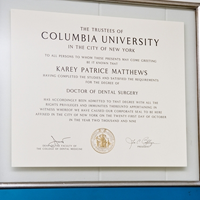 The image shows a framed diploma from Columbia University, which includes a degree in dental surgery awarded to Karey Patricia Matthews.