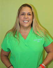 The image features a woman wearing a green shirt standing against a yellow background.